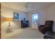 Relaxing bedroom featuring a comfortable recliner, stylish decor, and natural light at 9088 Sw 95Th Ave, Ocala, FL 34481