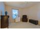 Inviting bedroom with a recliner, ample storage space, and a window for natural light at 9088 Sw 95Th Ave, Ocala, FL 34481