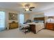 Serene bedroom with a dark-wood bedframe, natural light, and a ceiling fan at 9088 Sw 95Th Ave, Ocala, FL 34481