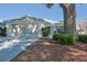Charming home exterior with a well-maintained lawn and mature shade trees at 9088 Sw 95Th Ave, Ocala, FL 34481