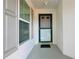 Close-up of the front door and window showcasing the home's entrance at 9088 Sw 95Th Ave, Ocala, FL 34481
