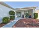 Inviting front entrance with well-manicured landscaping and colorful potted plants at 9088 Sw 95Th Ave, Ocala, FL 34481
