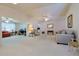 Spacious living room showcasing bright carpet, neutral paint, and comfortable seating arrangements at 9088 Sw 95Th Ave, Ocala, FL 34481