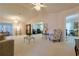 Spacious living room with vaulted ceilings, neutral carpet, and an open floor plan at 9088 Sw 95Th Ave, Ocala, FL 34481