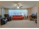 Bright living room featuring neutral carpet, a ceiling fan, and an abundance of natural light at 9088 Sw 95Th Ave, Ocala, FL 34481