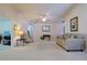 Neutral living room featuring bright carpet, neutral paint, and comfortable seating arrangements at 9088 Sw 95Th Ave, Ocala, FL 34481