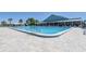 Large swimming pool with sun loungers and umbrellas near the community center for relaxing summer days at 9088 Sw 95Th Ave, Ocala, FL 34481