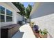 Side yard featuring a storage chest and air conditioning units along a walkway at 9088 Sw 95Th Ave, Ocala, FL 34481