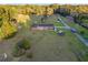 Expansive aerial view of the charming single-story home situated on a lush, sprawling lawn with mature trees at 9900 Ne 20 Terrace Rd, Anthony, FL 32617