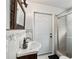 A bathroom features a glass door shower, an ornate framed mirror, and stylish sink faucet at 9900 Ne 20 Terrace Rd, Anthony, FL 32617