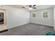 Bright bedroom featuring new carpet, ceiling fan, and multiple windows at 9900 Ne 20 Terrace Rd, Anthony, FL 32617