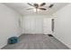 Bedroom featuring gray carpet, ceiling fan, and closet space at 9900 Ne 20 Terrace Rd, Anthony, FL 32617