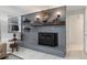 Charming gray brick fireplace with mantel, decorative accents, and classic design elements at 9900 Ne 20 Terrace Rd, Anthony, FL 32617