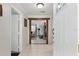 Welcoming foyer with white tile flooring and wooden beam accent at 9900 Ne 20 Terrace Rd, Anthony, FL 32617