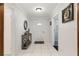 Light and bright foyer with tiled floors and decorative console table at 9900 Ne 20 Terrace Rd, Anthony, FL 32617