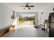 An open garage features a light blue ceiling and a long drive leading to the expansive front yard at 9900 Ne 20 Terrace Rd, Anthony, FL 32617