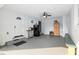 Spacious garage featuring storage, refrigerator, and door leading to outside at 9900 Ne 20 Terrace Rd, Anthony, FL 32617