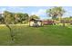 Large lot with a beautiful red brick home and gazebo featuring Adirondack chairs for outdoor gatherings at 9900 Ne 20 Terrace Rd, Anthony, FL 32617
