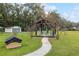 Wooden gazebo in the backyard featuring Adirondack chairs and lush landscaping in a spacious lawn at 9900 Ne 20 Terrace Rd, Anthony, FL 32617