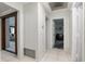 Open hallway with tile flooring leads to various rooms in the home at 9900 Ne 20 Terrace Rd, Anthony, FL 32617