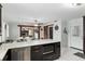 Open concept kitchen featuring dark wood cabinetry, white countertops, stainless appliances, and white tile flooring at 9900 Ne 20 Terrace Rd, Anthony, FL 32617