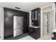 Kitchen features ample storage with dark cabinetry, a wine rack, and a stainless steel refrigerator at 9900 Ne 20 Terrace Rd, Anthony, FL 32617