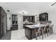 Well-equipped kitchen featuring dark cabinetry, stainless steel appliances, and a convenient island with bar seating at 9900 Ne 20 Terrace Rd, Anthony, FL 32617