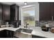 Close-up of a kitchen sink with elegant white countertops, modern stainless steel fixtures and stylish backsplash at 9900 Ne 20 Terrace Rd, Anthony, FL 32617