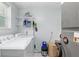 The laundry room features a washer, a dryer, shelving, and lots of storage space at 9900 Ne 20 Terrace Rd, Anthony, FL 32617