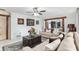 Spacious living room featuring stylish sofas, a decorative rug, and views into the dining area and kitchen at 9900 Ne 20 Terrace Rd, Anthony, FL 32617
