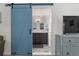Modern main bathroom featuring a barn door and dual vanity sinks at 9900 Ne 20 Terrace Rd, Anthony, FL 32617