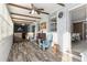 A sunroom features gray walls, wood floors, several windows and includes two wooden chairs at 9900 Ne 20 Terrace Rd, Anthony, FL 32617
