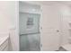 Bathroom showcasing modern design elements, including sleek fixtures, a walk-in shower, and a glimpse into the adjacent bedroom at 13032 Sw 84Th Terrace Rd, Ocala, FL 34473