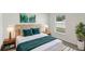 Stylized bedroom with a modern bed, lamps, side tables, vibrant wall art, and a tranquil view from the window at 13032 Sw 84Th Terrace Rd, Ocala, FL 34473
