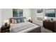 Cozy bedroom featuring a comfortable bed, sleek decor, modern art, and soft lighting creating a relaxing atmosphere at 13032 Sw 84Th Terrace Rd, Ocala, FL 34473