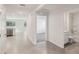 Open-concept entryway featuring neutral tile flooring, with views of the kitchen, living area, and bathroom at 13032 Sw 84Th Terrace Rd, Ocala, FL 34473