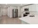 Modern kitchen with stainless steel appliances, white countertops, and ample storage space at 13032 Sw 84Th Terrace Rd, Ocala, FL 34473