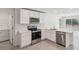 Bright kitchen featuring modern appliances, white cabinetry, and a convenient island at 13032 Sw 84Th Terrace Rd, Ocala, FL 34473