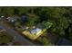 Charming home with a metal roof surrounded by lush greenery and a well-maintained lawn at 1309 Ne 33Rd St, Ocala, FL 34479