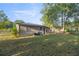 Fenced backyard perfect for pets or play, with a hose and outdoor tap for convenience and metal roof at 1309 Ne 33Rd St, Ocala, FL 34479