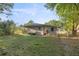 Fenced backyard perfect for pets or play, with a hose and outdoor tap for convenience and metal roof at 1309 Ne 33Rd St, Ocala, FL 34479