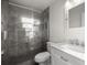 A modern bathroom features a glass shower, marble vanity, and sink at 1309 Ne 33Rd St, Ocala, FL 34479