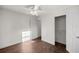 Spacious bedroom with modern wood-look flooring, a ceiling fan, and a conveniently located closet at 1309 Ne 33Rd St, Ocala, FL 34479