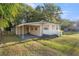 Charming home featuring a covered carport, fresh paint, a picket fence, and well-maintained landscaping at 1309 Ne 33Rd St, Ocala, FL 34479