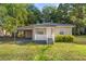 A charming home with a covered porch and carport offers a welcoming feel and practical features at 1309 Ne 33Rd St, Ocala, FL 34479