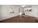 Bright living room with wood-look flooring, ceiling fan, and open to kitchen at 1309 Ne 33Rd St, Ocala, FL 34479