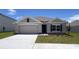 Charming single-story home featuring a well-maintained lawn, neutral paint, and a two-car garage at 15814 Se 101St Cir, Summerfield, FL 34491