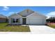 Charming single-story home featuring a two-car garage, well-maintained lawn, and classic architectural details at 15820 Se 101St Cir, Summerfield, FL 34491