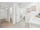 Bright main bathroom with double sink vanity, and open doorway to water closet and main bedroom at 16102 Sw 27Th Terrace Rd, Ocala, FL 34473