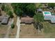 Expansive aerial view of single-story home with inground pool, long driveway, lush trees and well maintained lawn at 164 Ne 53Rd St, Ocala, FL 34479